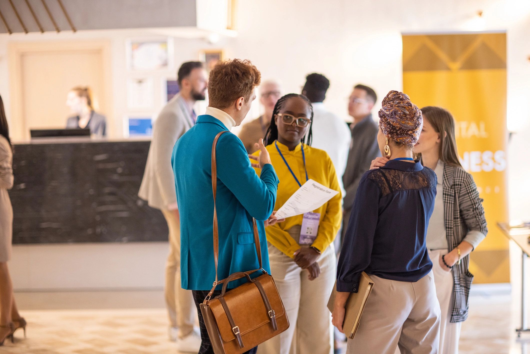 Business professionals networking before a conference